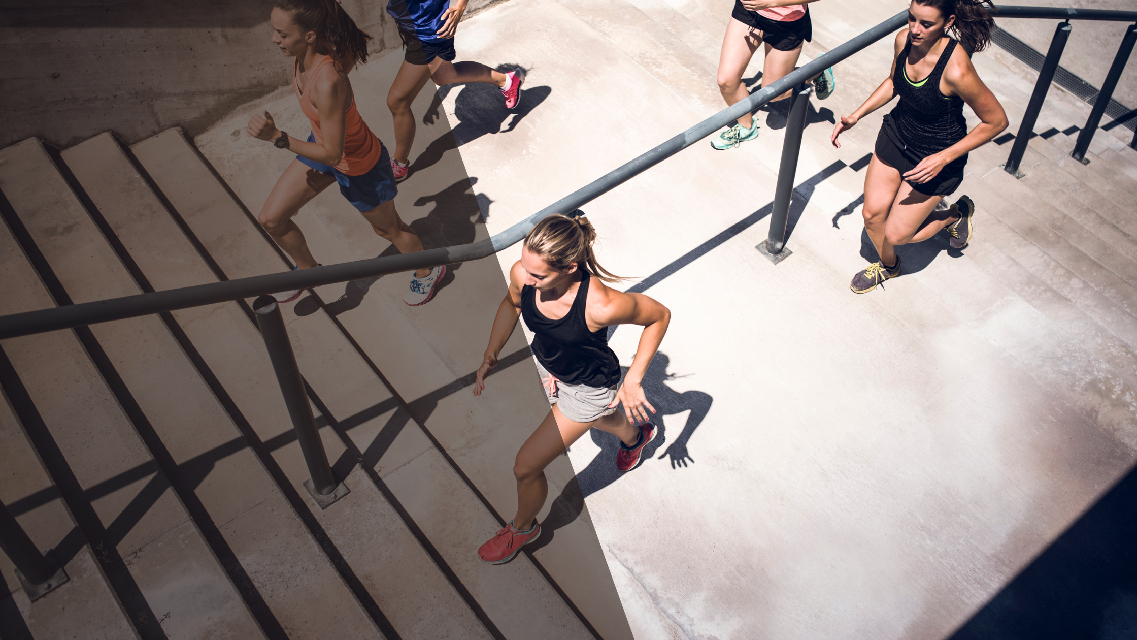 Group of people running up a set of outdoor stairs.